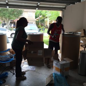 Dr. Helen &Brother Kwabena packing barrels